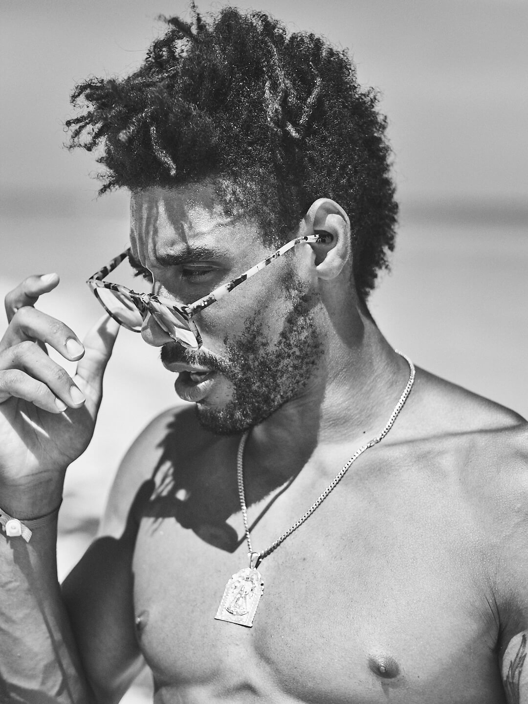 Fuji X Pro2 with xf 56mm f1.2 - Black and White model wearing sunglasses on the beach. Playa del Carmen, Mexico - Model: Marquis