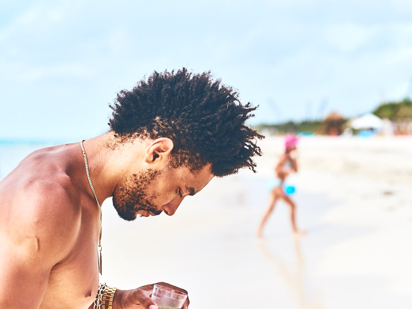 Fuji X Pro2 with xf 56mm f1.2 - Model on the beach drinking a beverage. Playa del Carmen, Mexico - Model: Marquis