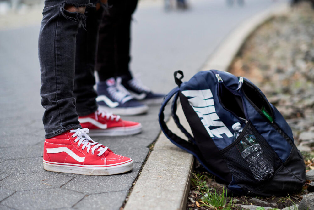 Fuji X Pro2 with xf 56mm f1.2 - Men's Fashion Photography in Riverside Park New York with Nike bookbag red sneakers - Model: Demetric