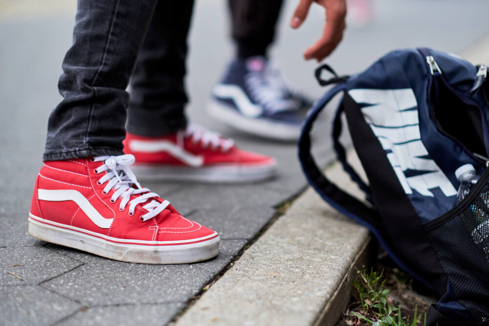 Fuji X Pro2 with xf 56mm f1.2 - Men's Fashion Photography in Riverside Park New York with Nike bookbag red sneakers - Model: Demetric