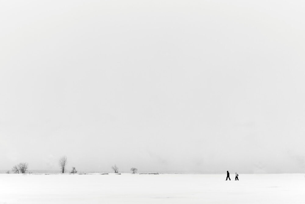 Canon 5D Mark iii with ef 50mm 1.8 - Landscape Photography - Two people walking on a frozen river at Rene Levesque Park Montreal Quebec